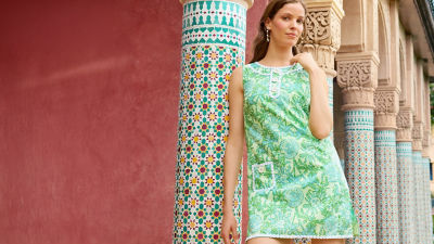 Woman wearing a green and white printed shift dress