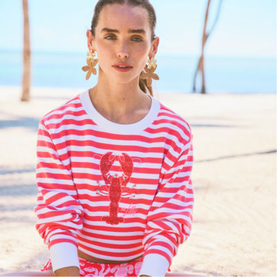 Woman wearing a red and white striped sweatshirt