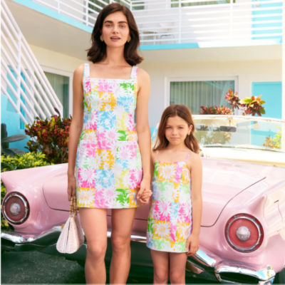 Woman and little girl wearing matching multicolored dresses