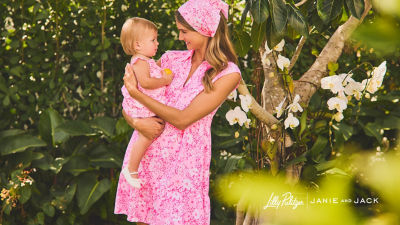 Woman and a baby wearing matching pink printed outfits
