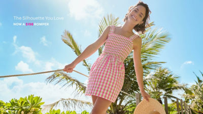 Woman in a  green and pink gingham romper
