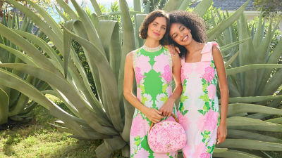 Women wearing green and pink printed dresses