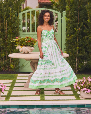 Woman in a green and white printed dress