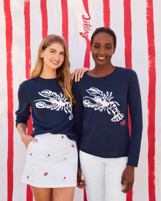 Women wearing navy sweaters with white bottoms