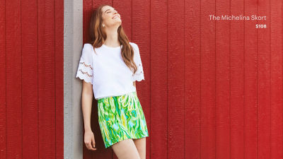 Woman in a white top and a green printed skort