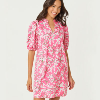 Woman wearing a green and pink floral short dress