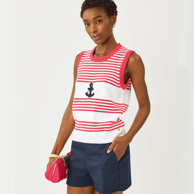Woman wearing a red and white striped sweater vest with navy shorts