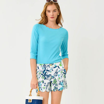 Woman wearing a blue top and printed shorts