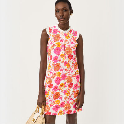 Woman wearing an orange pink and white printed dress