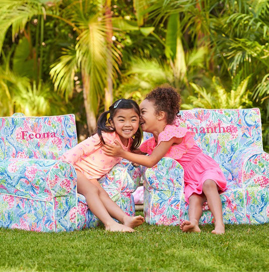 kids laughing sitting in lilly x pottery barn chairs